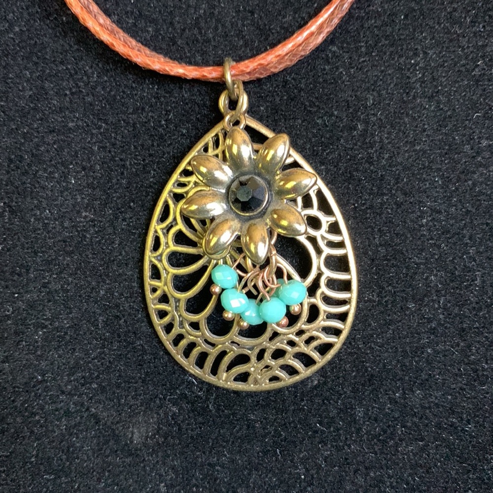 NWOT Boho style necklace. 16 inch with a 2 inch extender. Two tone leather cord.